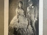a black and white photo of a man and a woman in formal attire