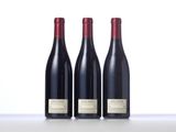 three bottles of wine sitting on top of a table