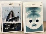 two bags with pictures of animals on them on a table