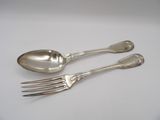 two silver spoons and a fork on a white surface