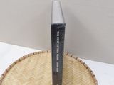 a box of mascara sitting on top of a bamboo tray