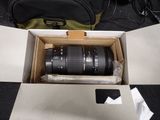 a box with a camera lens in it on the floor