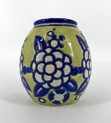 a blue and green vase with a flower design on it