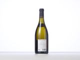 the bottle of white wine is sitting on the table