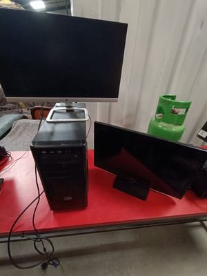 three computers sitting on a red table in front of a tv