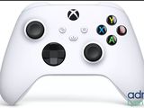 a close up of a white xbox controller on a white surface