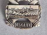 an image of a silver badge with a picture of a farm