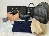 many bags and purses laid out on a table