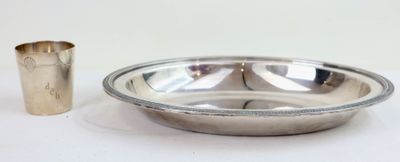 a silver bowl and a silver cup on a white table