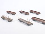 six toy train cars that are lined up on a white surface