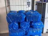 many bags of blue plastic sitting on the floor