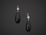 a pair of black and white diamond earrings