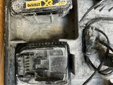 an image of a tool box with a corded drill and two batteries in it