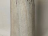 a statue of a woman holding a bird on her arm
