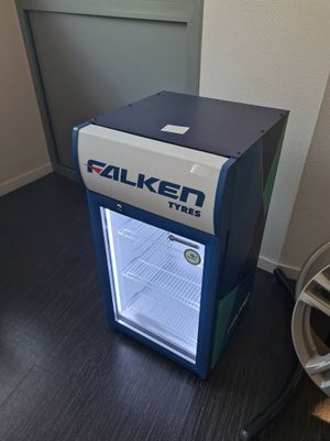 a small refrigerator that is sitting on the floor