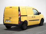 the yellow van is parked in a room with a checkered floor