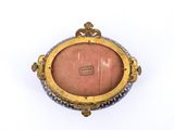 a picture of a blue and gold broochle on a white background