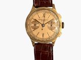 une image d'une montre-bracelet en or avec un bracelet en cuir marron