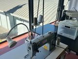 an image of a sewing machine sitting on top of a table next to a window