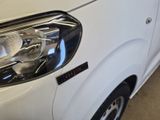 a close up of a car ' s headlight with a sticker on it