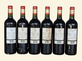 six bottles of red wine are lined up in a row