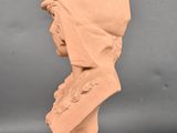 a close up of a clay sculpture of a woman ' s head