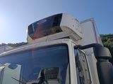 a white truck with a television on top of it