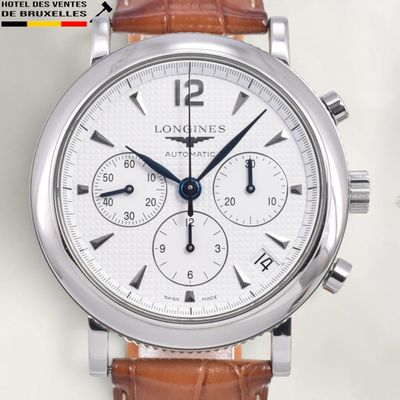 a close up of a wrist watch with a brown strap