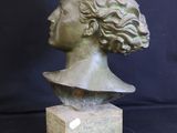 an image of a bronze bust of a woman on a marble base