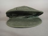 a green hat sitting on top of a white table