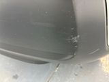 the front bumper of a car with scratches on it