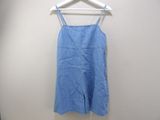 blue overalls hanging on a hanger against a white wall