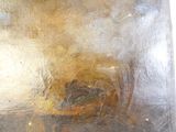 a close up of a metal plate with a painting on it