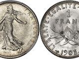 a silver coin with the image of a woman holding a tennis racquet