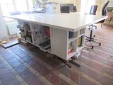 a desk with a computer on it in a room