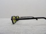 sunglasses on a white surface with a white wall in the background