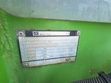 a green machine with a hose attached to it
