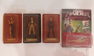 three action figures of a woman and a man are in plastic boxes