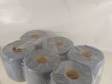Plusieurs rouleaux de papier toilette sont emballés dans du plastique sur un comptoir