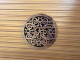 a close up of a wooden instrument with a decorative design on it