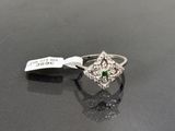 a close up of a diamond ring on a table with a price tag