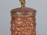 a small metal container with a bird on top of it