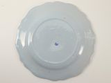a blue plate with a blue center on a white table