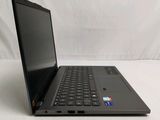 the laptop is open on a white surface with a white background