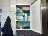 a medicine cabinet in the corner of a bathroom