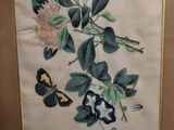 framed picture of a painting of a butterfly and flowers on a wall