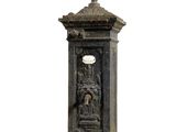 a clock that is sitting on a pedestal on a white background