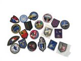 several different military patches and patches are arranged on a white surface