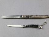 two knives that are laying next to each other on a table