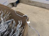 a cardboard box with a bunch of scissors in it